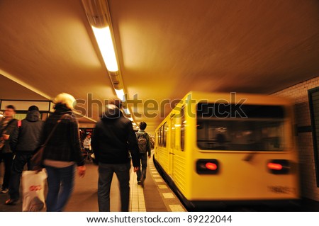 People crowd walking at subway, train in motion