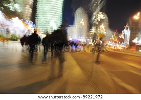 People crowd walking in the city at night (blurred scene)