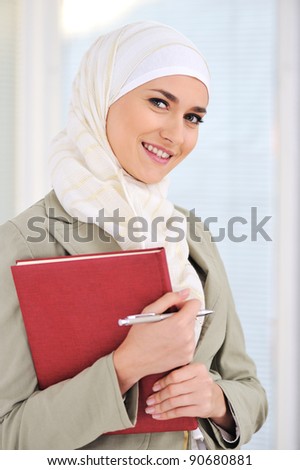 Muslim Caucasian female student with notebook and pen