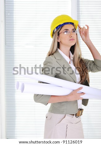 Female engineer with blueprints at business office