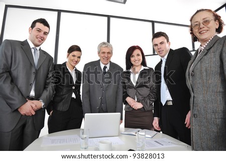 Group of business people standing at office and smiling