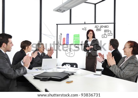Business woman drawing a diagram during the presentation and receiving applause