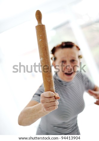 Angry older woman with rolling pin