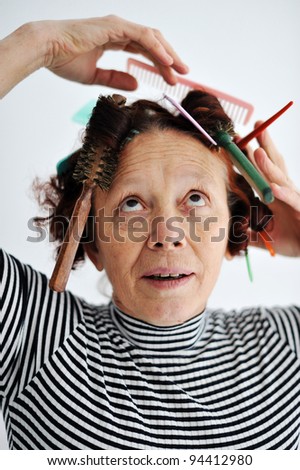 Senior female multitasking with many combs in hair