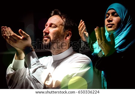 Muslim father and mother praying or god with their hands up