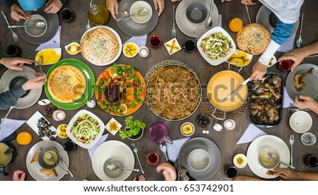 Top view of family and friends eating food on table