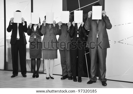 business team standing holding white papers