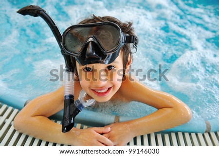 Kid in pool with diving equipment