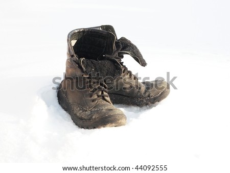 Old boots on snow