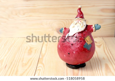 Happy Christmas Santa Claus doll on wooden background with copy space