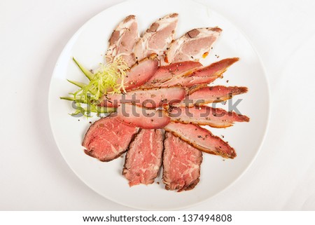 sliced rare beef, roast covered in pepper and herbs