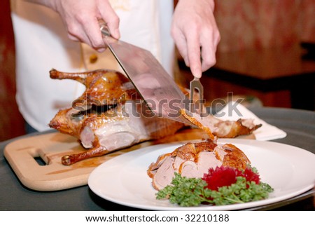 Chef cutting duck in chineese restaurant