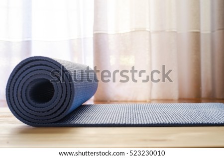 Blue Mat for yoga,fitness or pilates.Shallow deep of field. Blur style background.Copy space.