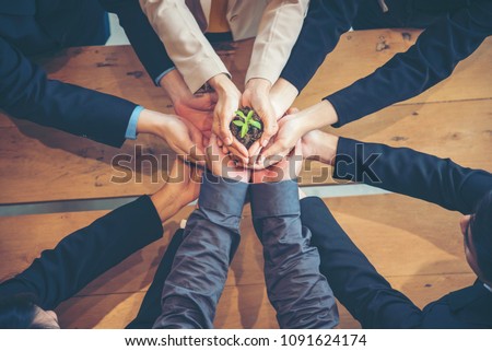 Sustainability Collaboration Green Ecology Business Company. Trust Partners Team Welcome hands holding green plant together. Hands Stacked of Partners with Green Sustainable Develop Business Concept.