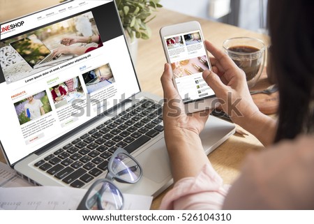 Online Shopping Website on Laptop. Easy Ecommerce Website Shop Online by Smartphone, iPhone, iPad and Laptop. Hands Using Smartphone Shopping Cart Reading Online Article, Blog. Shopping Online Concept