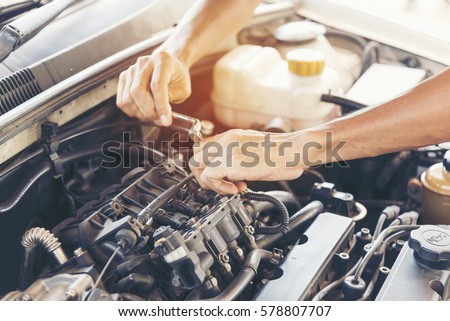 Mechanic man fixing car.