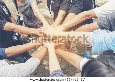 Concept partnership. Group of Photographers  Partners Team with hands together trusted each other. Hand Holding of business partners.Trust business in authentic of people. Trust Concept.