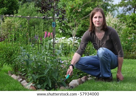 Happy woman works in the garden