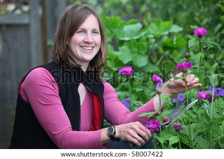 Happy woman works in the garden