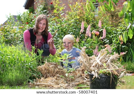 Happy woman and son work in the garden