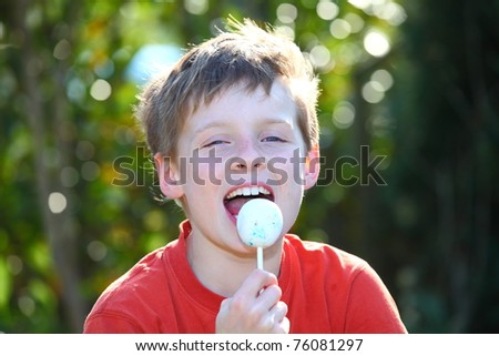 Young boy eating candy