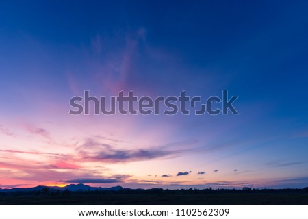 Evening sky,amazing colorful dusk sky and dramatic sunset cloud on twilight,majestic sunlight on cloud fluffy,idyllic nature peaceful background,beauty dark blue,purple sky over silhouette mountain