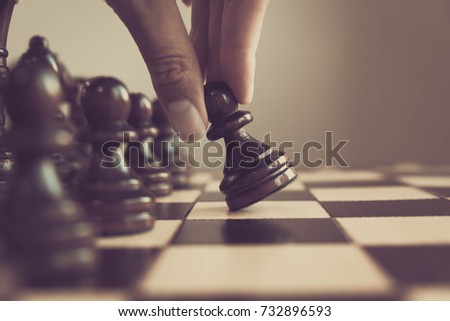 Chess game, chess player makes a move the white pawn one step forward.