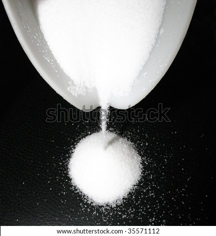 Sugar grains run out of a bowl...
