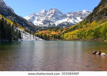 Maroon Bells and Lake in Fall - Autumn view of snow coated Maroon Bells and crystal clear Maroon Lake, Aspen, Colorado, USA.