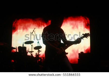 Sillhouette of a man playing a lead guitar role in a concert in Malaysia
