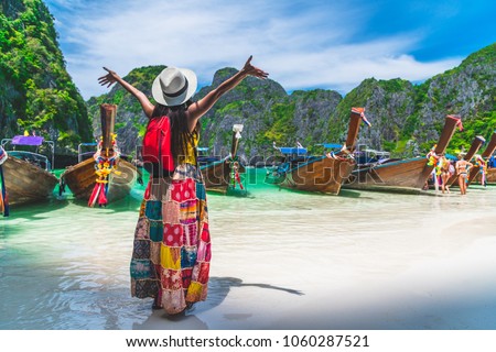 Traveler Asian woman in summer dress joy relaxing on natural sea beach, Maya beach, Phi Phi island, Krabi, Travel in Thailand, Beautiful destination place Asia, Summer holiday outdoor vacation trip