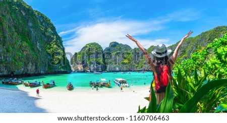 Happy travel vacation destination, Wide panorama banner nature landscape, Travelers summer holiday outdoor Tourism woman with hand up relaxing beautiful famouse beach Maya bay, Landmark Thailand, Asia
