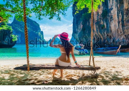 Traveler woman in bikini relaxing on swing joy beautiful nature scenic landscape island Krabi, Landmark travel Phuket Thailand beach, Tourist on summer holiday vacation, Tourism destination Asia trips