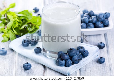 Smoothie with fresh blueberries on wooden table
