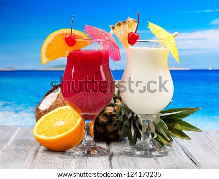 tropical cocktails with fresh fruits  on a beach