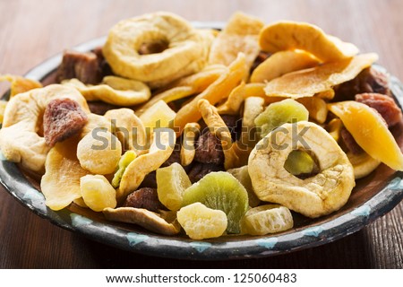 mix of dried fruits on wooden table