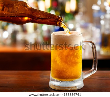 Beer Pouring Into Mug In A Bar