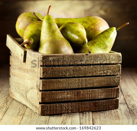 fresh pears in wooden box