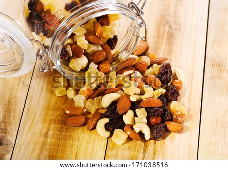 mixed nuts and dried fruits on wooden table