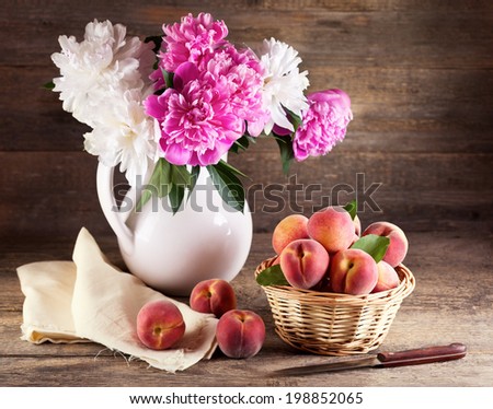 Still life with bouquet of peonies and peaches