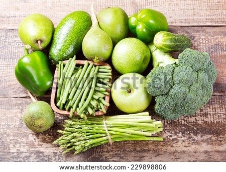 green fruit and vegetables on wooden background