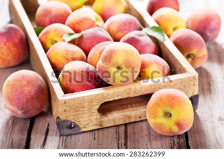 fresh peaches in wooden box