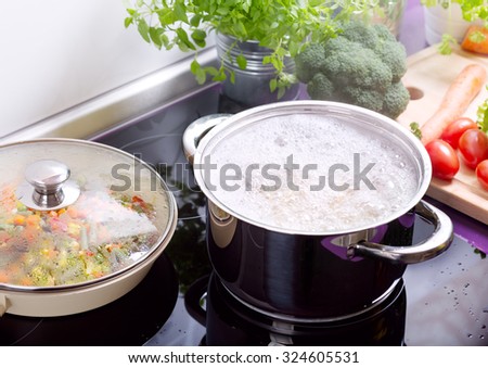 pan of boiling water with spaghetti on the cooker in the kitchen