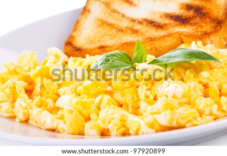 scrambled eggs with green basil and toast