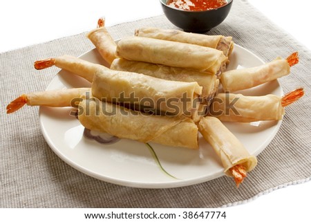 Stack of spring rolls on a plate isolated on a white background