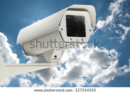 New security camera with cloudy sky as a background.