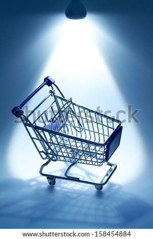 A beam of light comes from above and illuminates a cart.