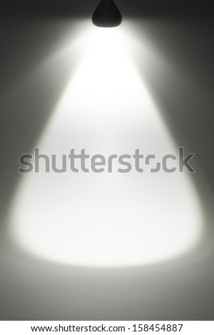 A beam of light comes from the top of an LED lamp.