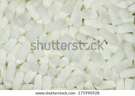 Background with white chips, which are used as packaging material.