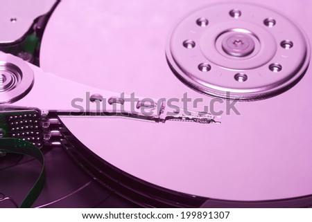 Close up of an opened hard disk with visible read head.